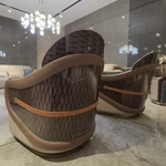 Cream Curved Leather Sofa with Dark Green Fan-Stitched Panels and Laced Edge Details
